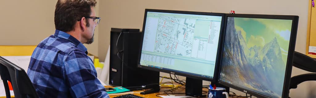 City of Summerside staff member reviewing maps at a workstation